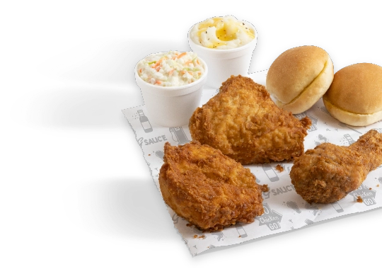 Three pieces of golden fried chicken, a side of coleslaw and mashed potatoes with gravy, and two butter rolls.